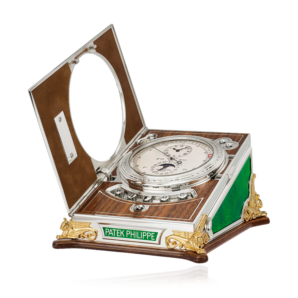 Patek Philippe compass in an open wooden box on a white background
