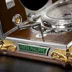 Close-up of a Patek Philippe watch with intricate design and gold accents.