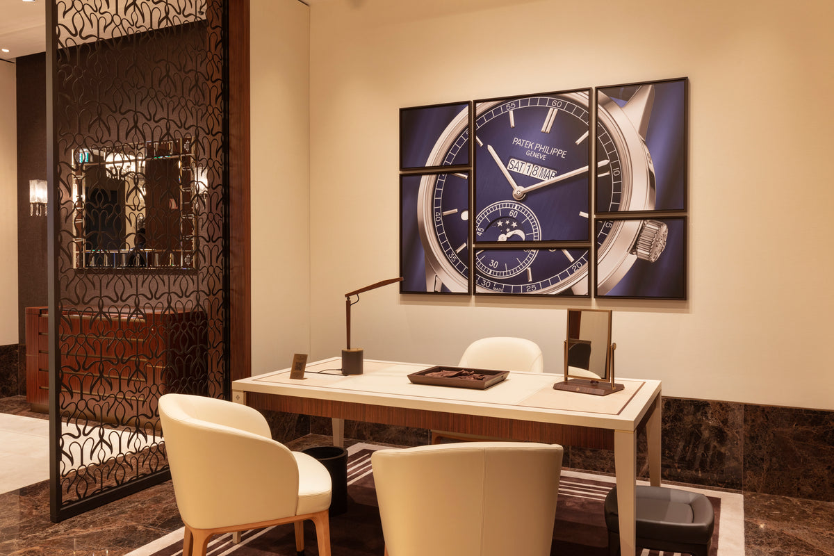 Modern office interior with a large wall clock and decorative screen.