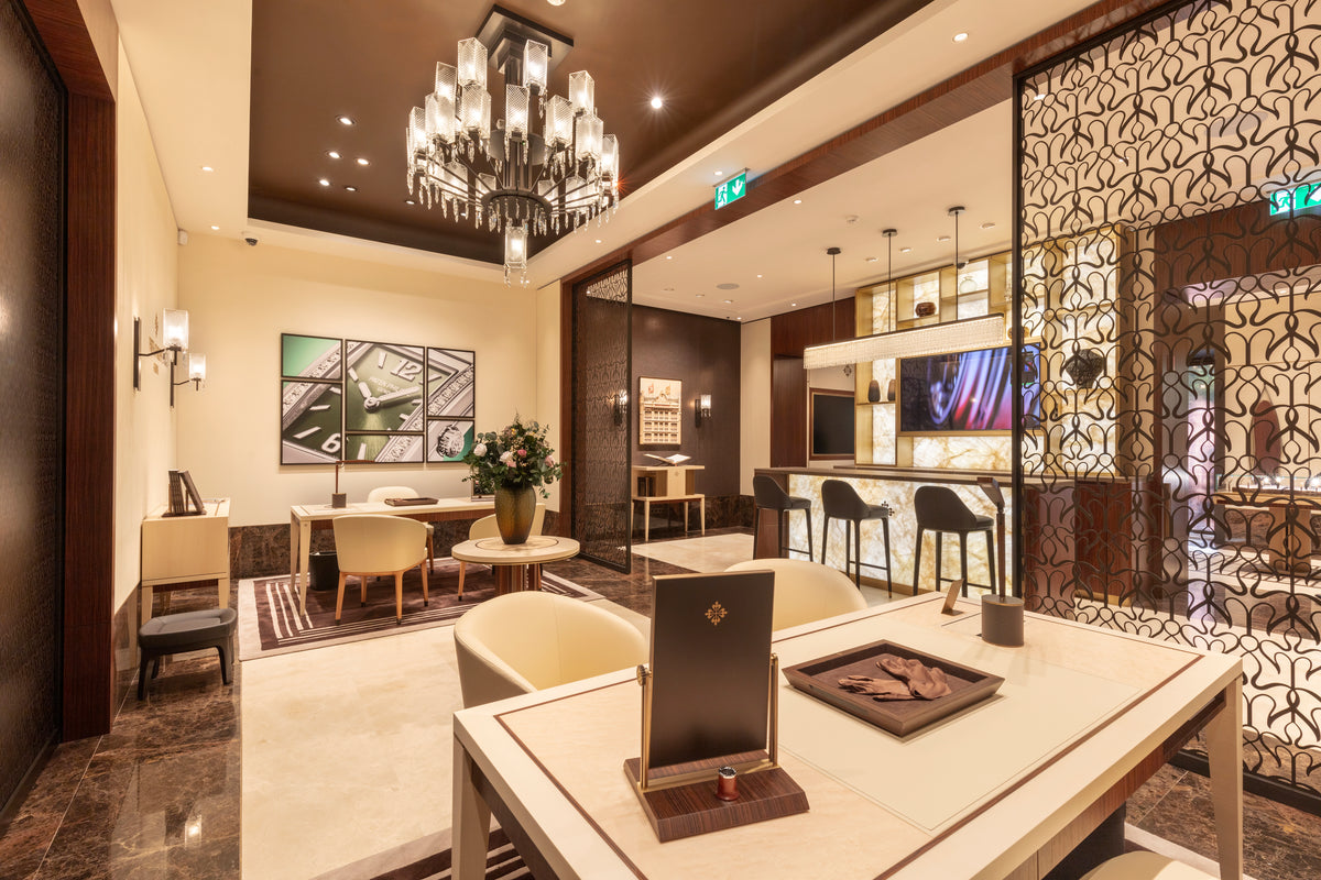 Luxurious living room with modern decor and a chandelier.