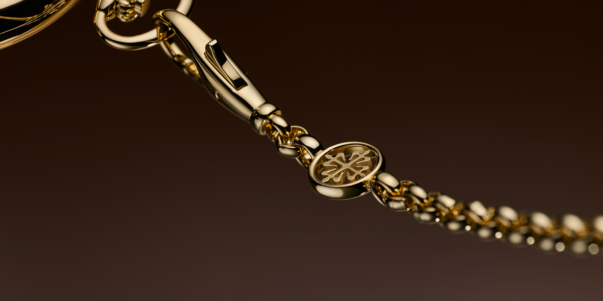 Close-up of a gold bracelet with a dark background