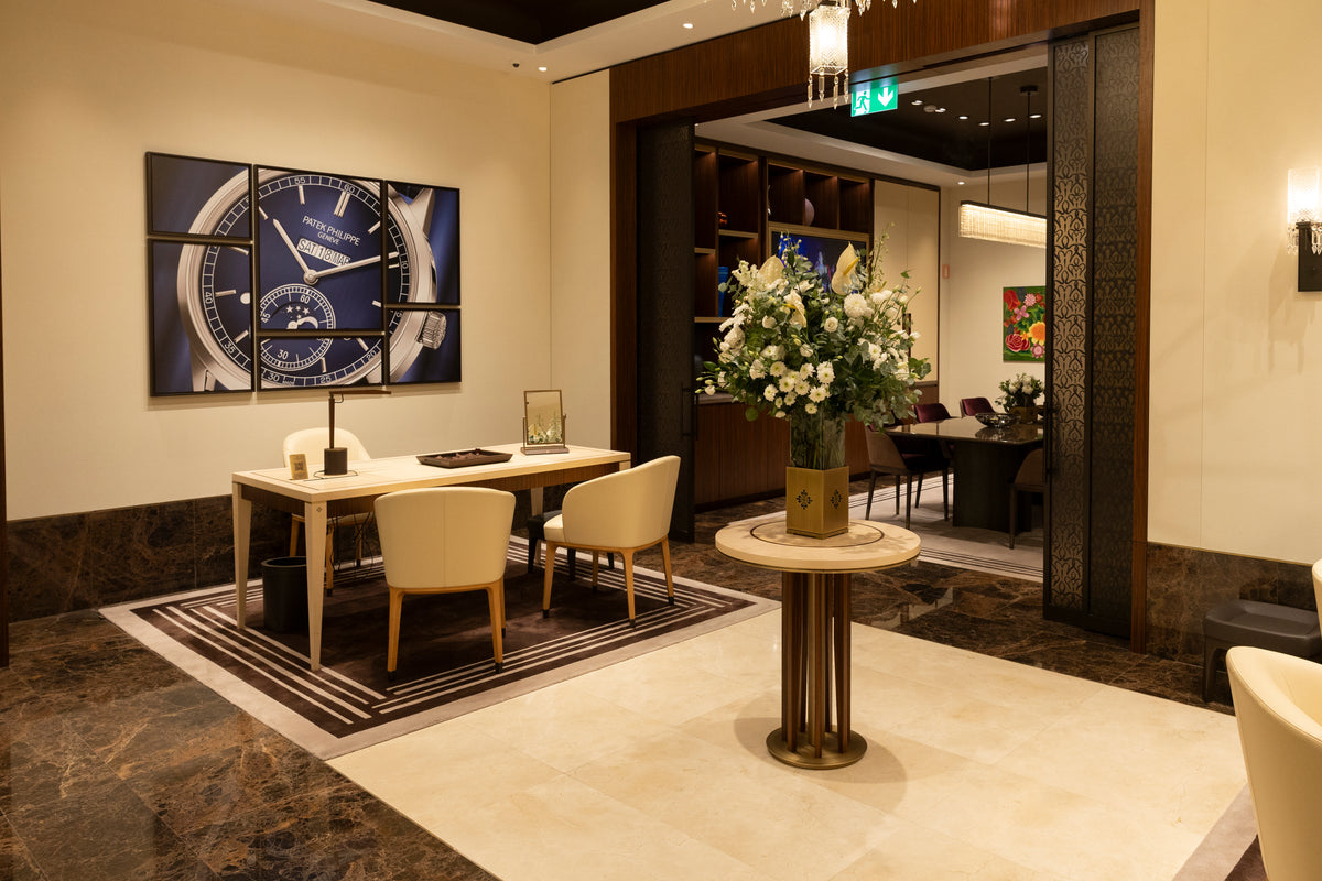 Modern office interior with a desk, chairs, and decorative elements.