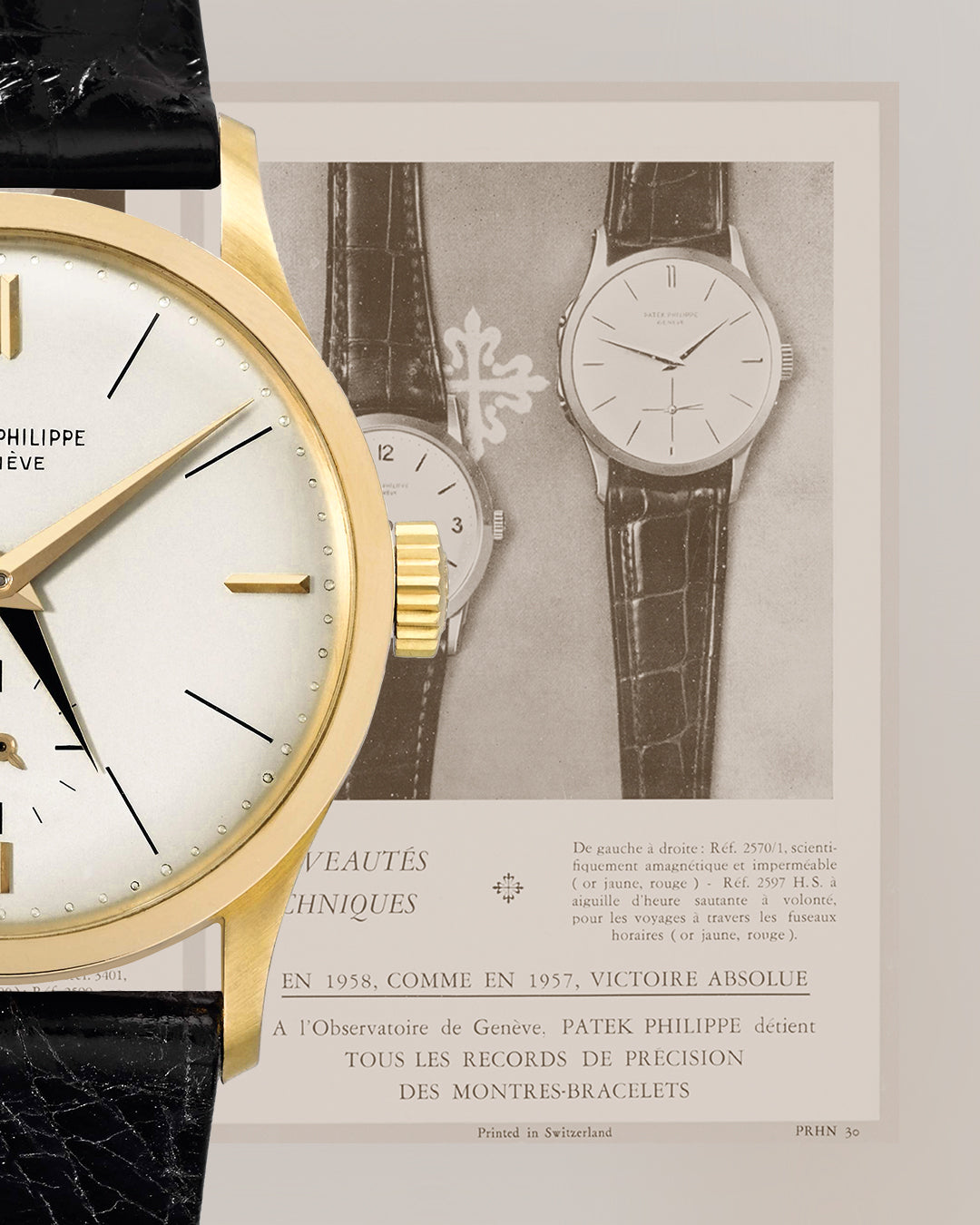 Gold watch with white face and black hands on a textured surface, with a framed advertisement in the background.